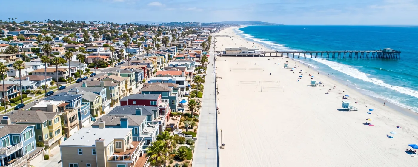 Buy a home in Hermosa Beach CA — get 1% cash back at closing Hermosa Beach colorful beachfront homes along the Strand with pier aerial view — Portfolio Home Realty buyer agent