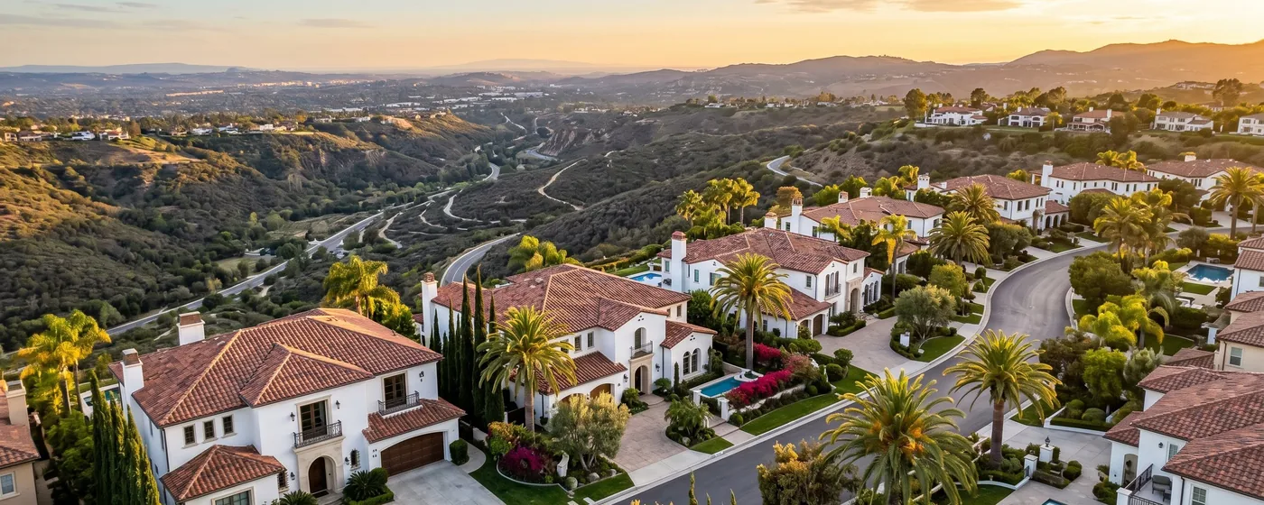 Buy a home in Laguna Niguel CA — get 1% cash back at closing Laguna Niguel affluent hillside community with elegant Spanish homes and canyon views at golden hour — Portfolio Home Realty buyer agent